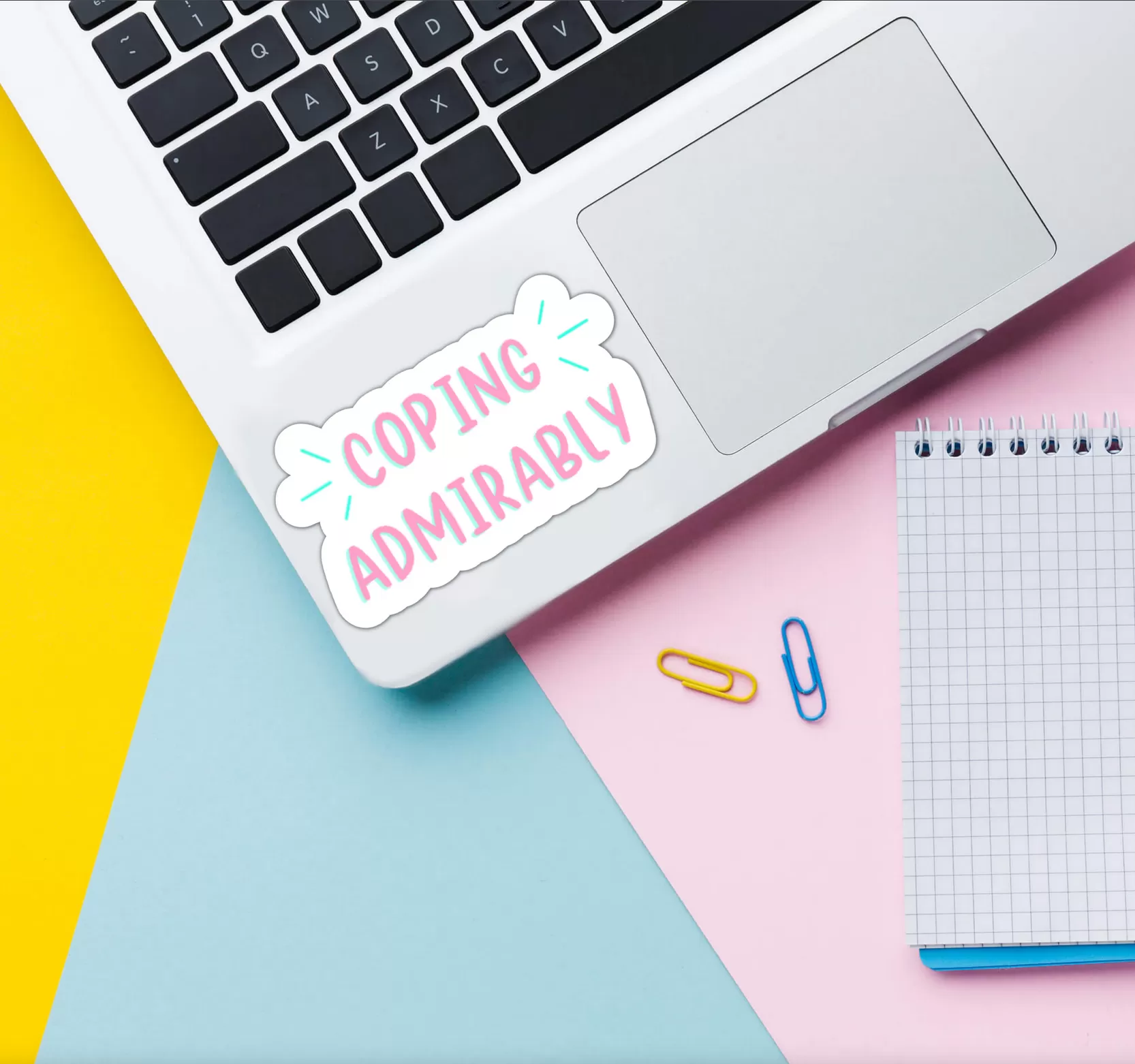 coping admirably sticker stuck to a laptop