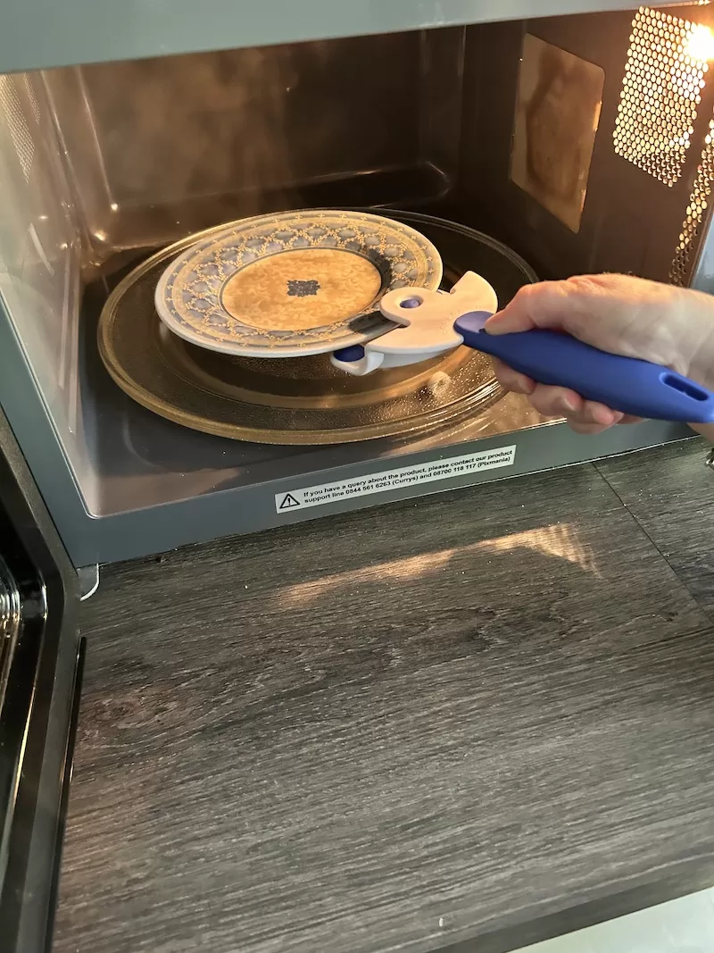 Small Plate being taken from a microwave using Buckingham Coolhand