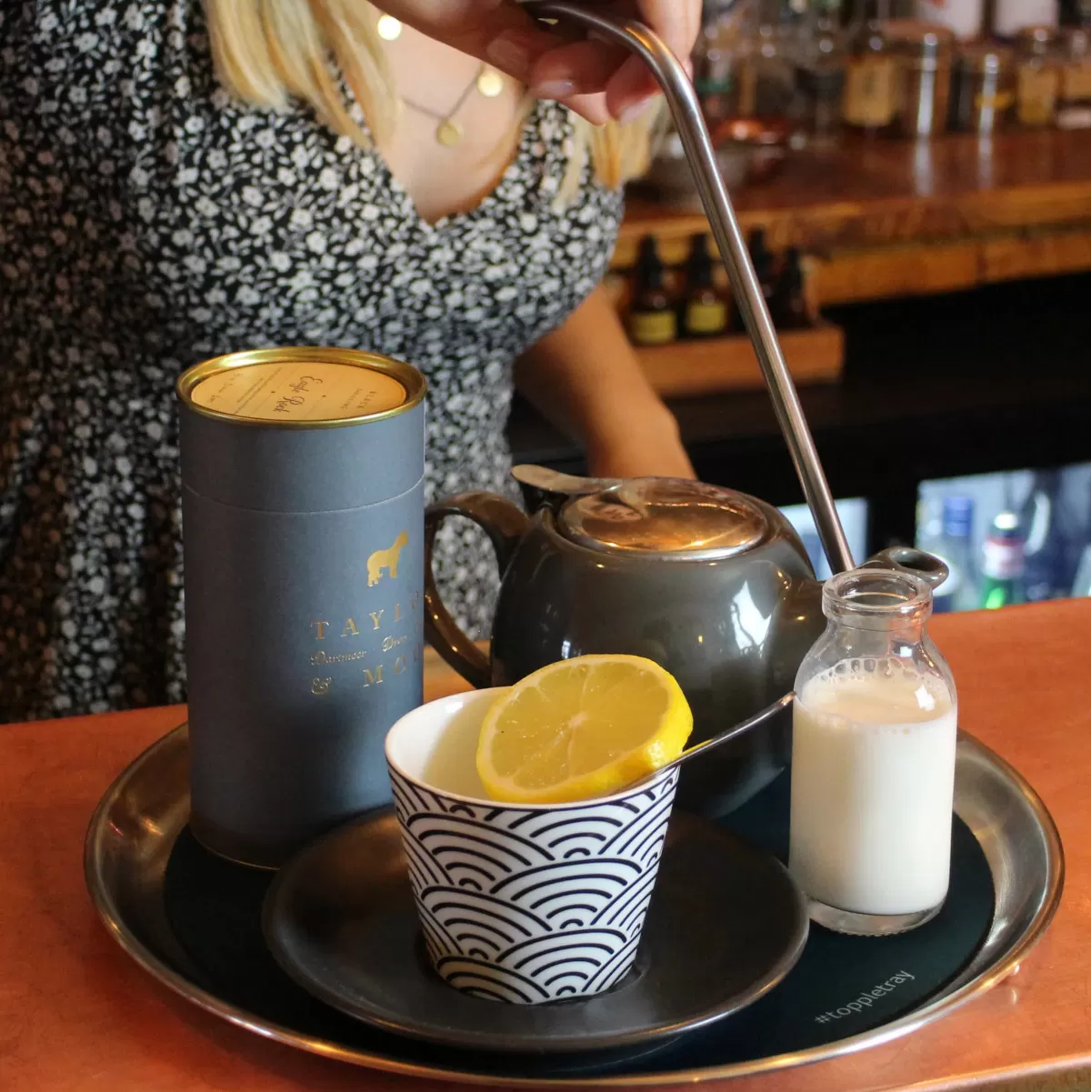 Topple Tray Single-handed Tray carrying tea and coffee in a cafe.