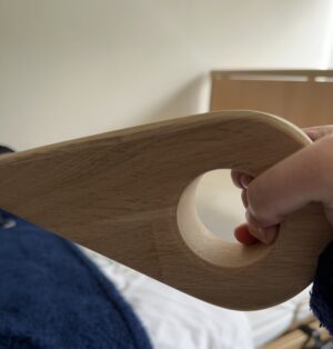 Bed wedge mattress lifter being held to show the handle in use