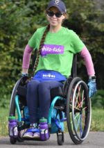 Rebecca from Whizzkidz in a wheelchair with a green t shirt and a long ponytail