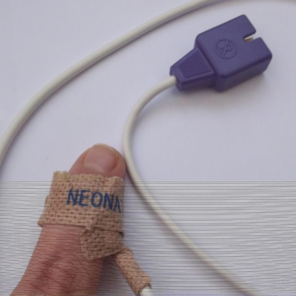 A finger with an spo2 probe attached with an adhesive plaster covering
