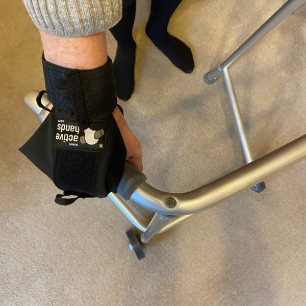 Using a black lite gripping aid glove to hold a walking frame