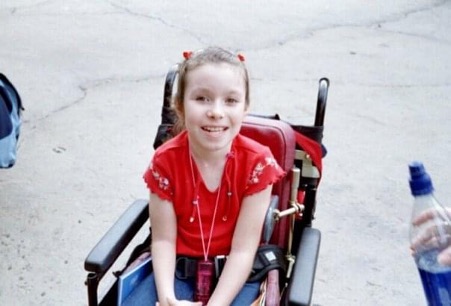 Emma Purcell as a 10-year-old child in her manual wheelchair