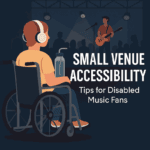 A digital illustration depicting an inclusive live music scene in a small venue. In the foreground, a wheelchair user with short brown hair and large over-ear headphones faces the stage, enjoying the performance. A hydration bottle with a long straw is attached to their wheelchair, symbolising practical accessibility needs. They are wearing casual clothes — an orange T-shirt, blue trousers, and trainers — and appear relaxed and engaged. In the background, a guitarist performs under soft stage lighting, with a microphone stand nearby and a silhouetted audience watching. The stage is framed by rigging and spotlights, creating a lively gig atmosphere. The overall colour palette is warm and inviting, evoking the energy and intimacy of a grassroots music event. Overlay text on the right side reads: “Small Venue Accessibility: Tips for Disabled Music Fans.” The image conveys inclusivity, empowerment, and the joy of live music for disabled audiences.