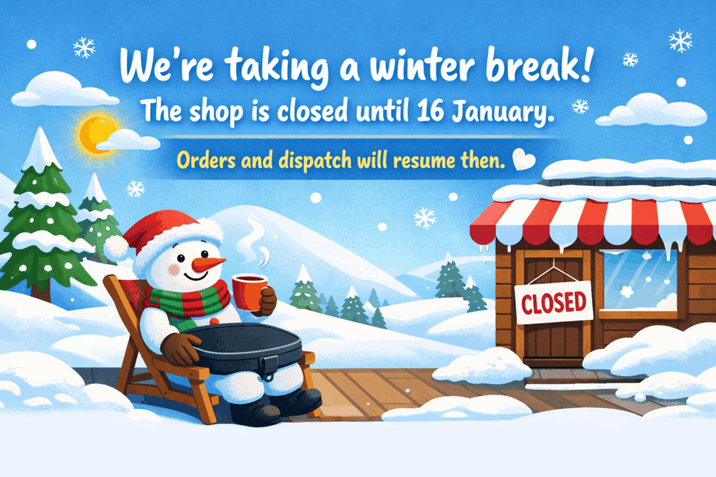 Illustration of a smiling snowman relaxing in a deck chair with a black Trabasack-style lap tray on their lap, holding a hot drink, beside a snowy shop with a “Closed” sign and text saying the shop is closed until 16 January.
