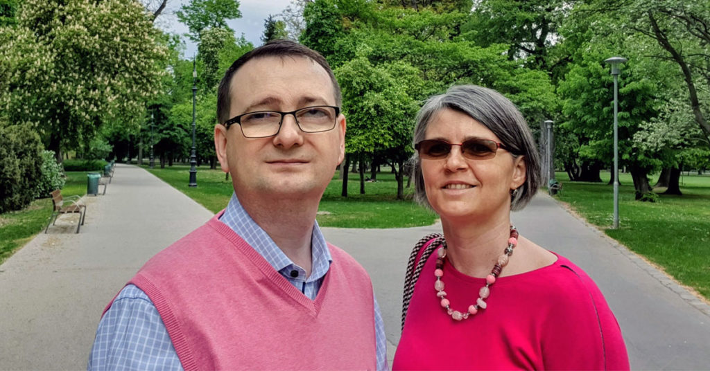 Értéksziget founders Zoltán József Szabó and Alexa Szabó standing together in a park in Budapest.